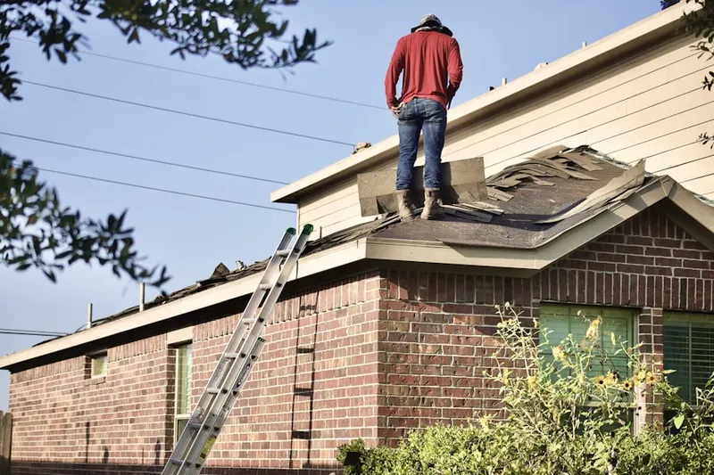 Professional roofer working on a residential roof in Stormfield